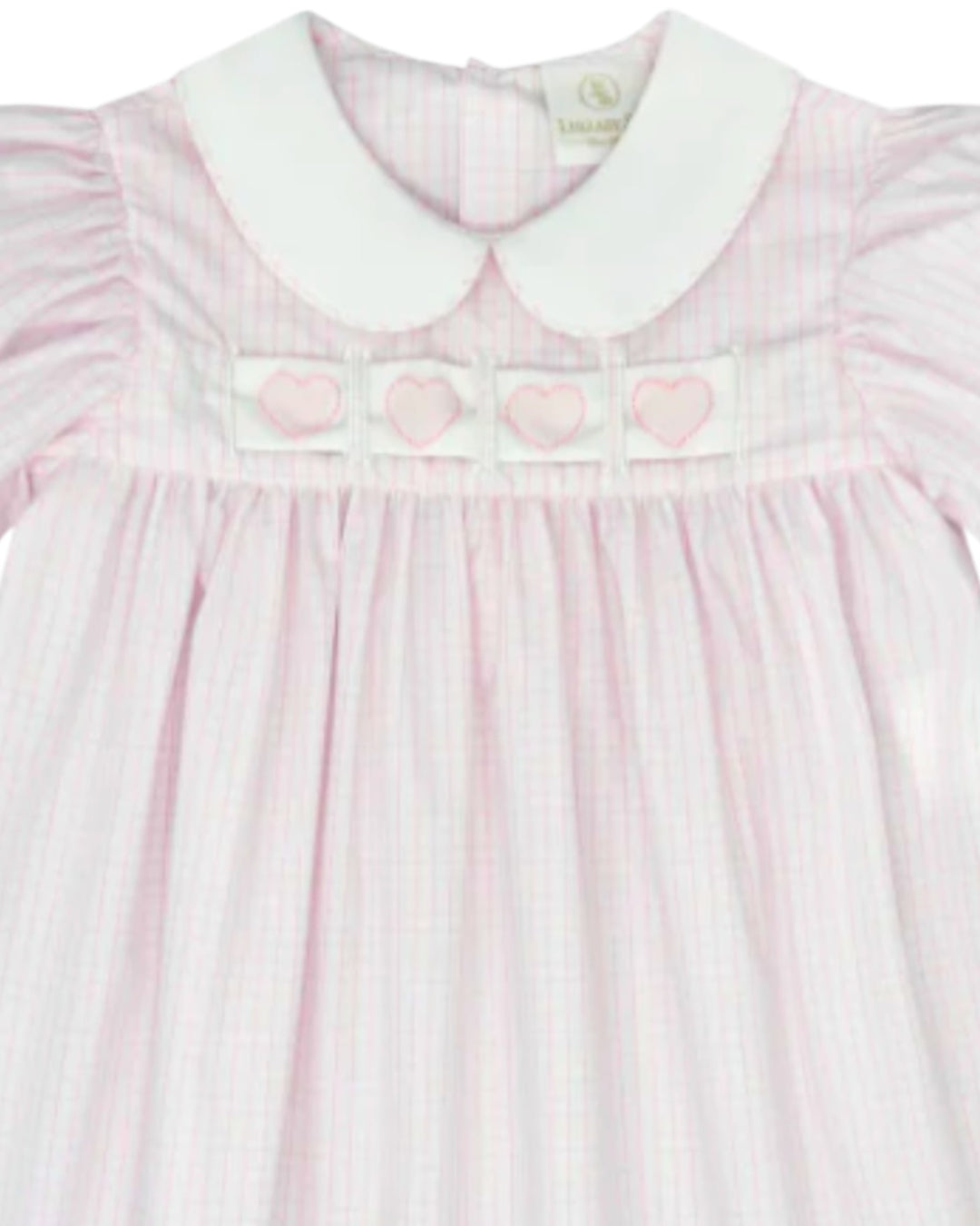 Pink dress with heart patterns on a white background