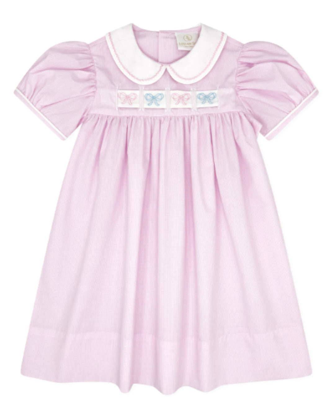 A light pink baby dress with a white Peter Pan collar, smocked bodice, and embroidered pastel bow details across the chest, that store