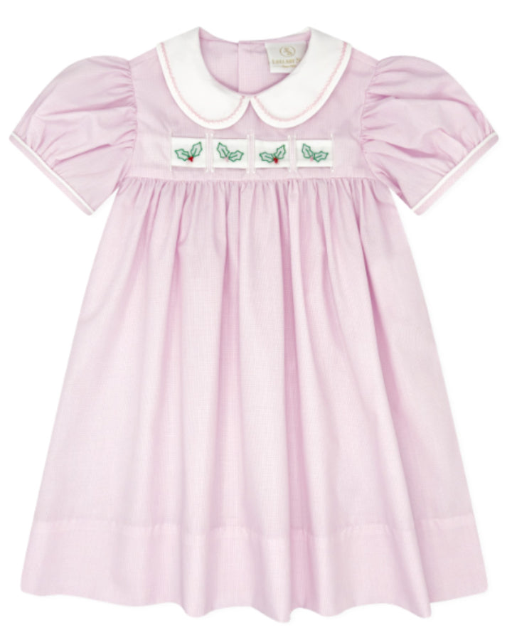 A light pink baby dress with a white Peter Pan collar, smocked bodice, and embroidered green butterflies on the chest, shown against a plain white background, that store