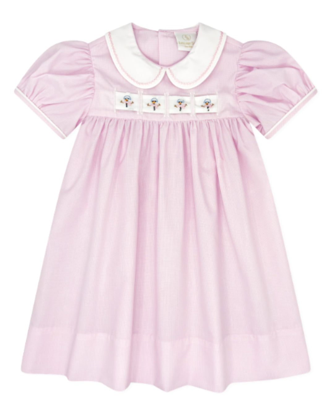 A light pink baby dress with a white Peter Pan collar, white piping on the sleeves, and a smocked chest panel featuring four embroidered flowers, that store