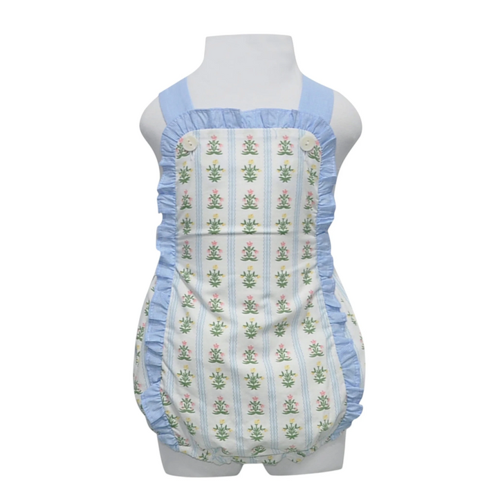 Baby romper with blue trim and floral pattern on a mannequin against a white background