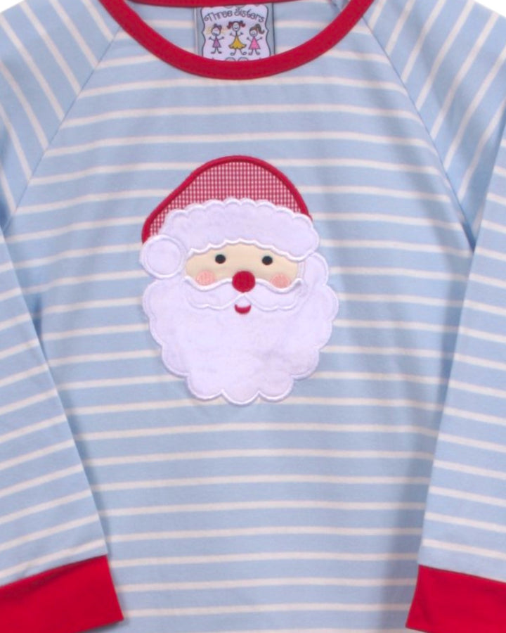 A close-up of a baby long-sleeve shirt with light blue and white horizontal stripes, featuring a red crew neck, red cuffs, and a white embroidered Santa Claus face patch on the chest, that store