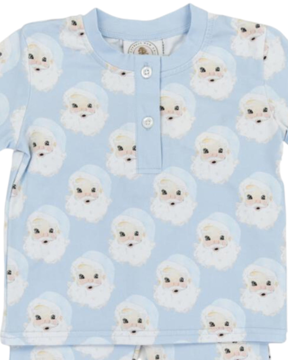 Children's pajama top with dog pattern on a light blue background
