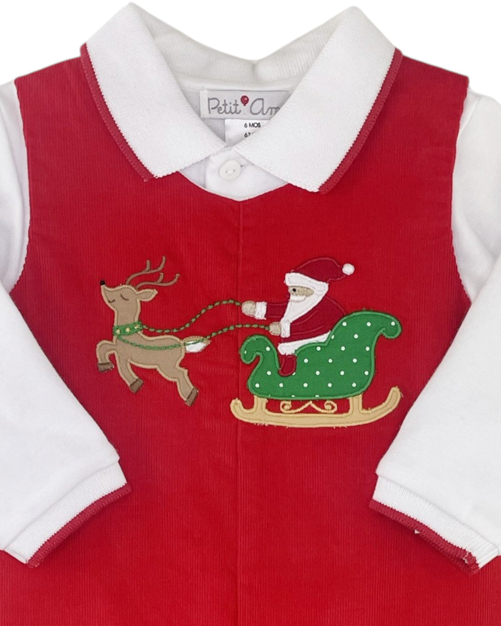 Red children's outfit with Santa and reindeer design on a white background