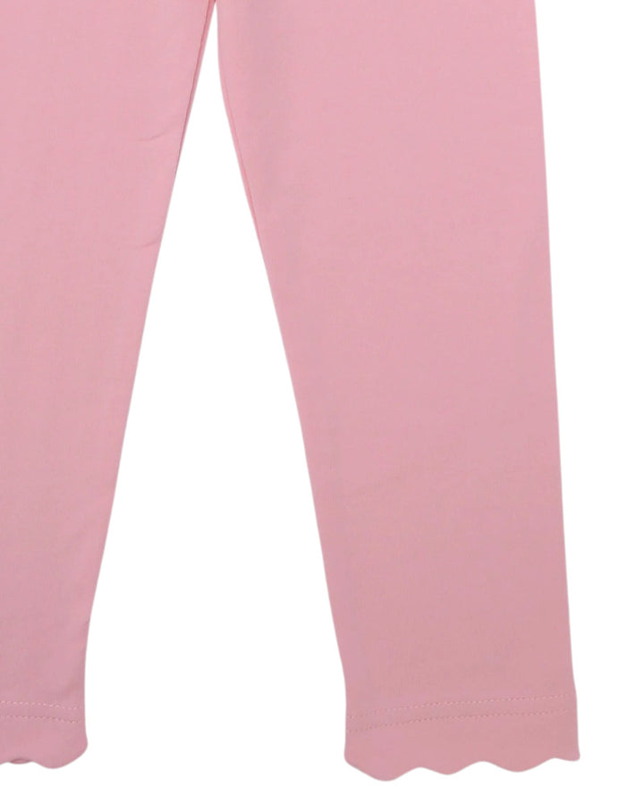 Close-up of pink leggings or tights with a scalloped hem, shown against a plain white background, that store
