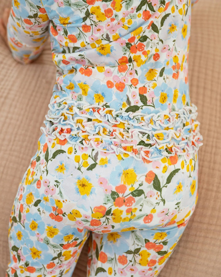 Floral patterned outfit with ruffled waistband on a beige background