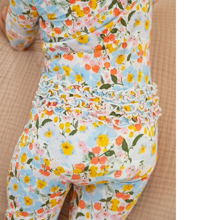 Floral patterned outfit with ruffled waistband on a beige background