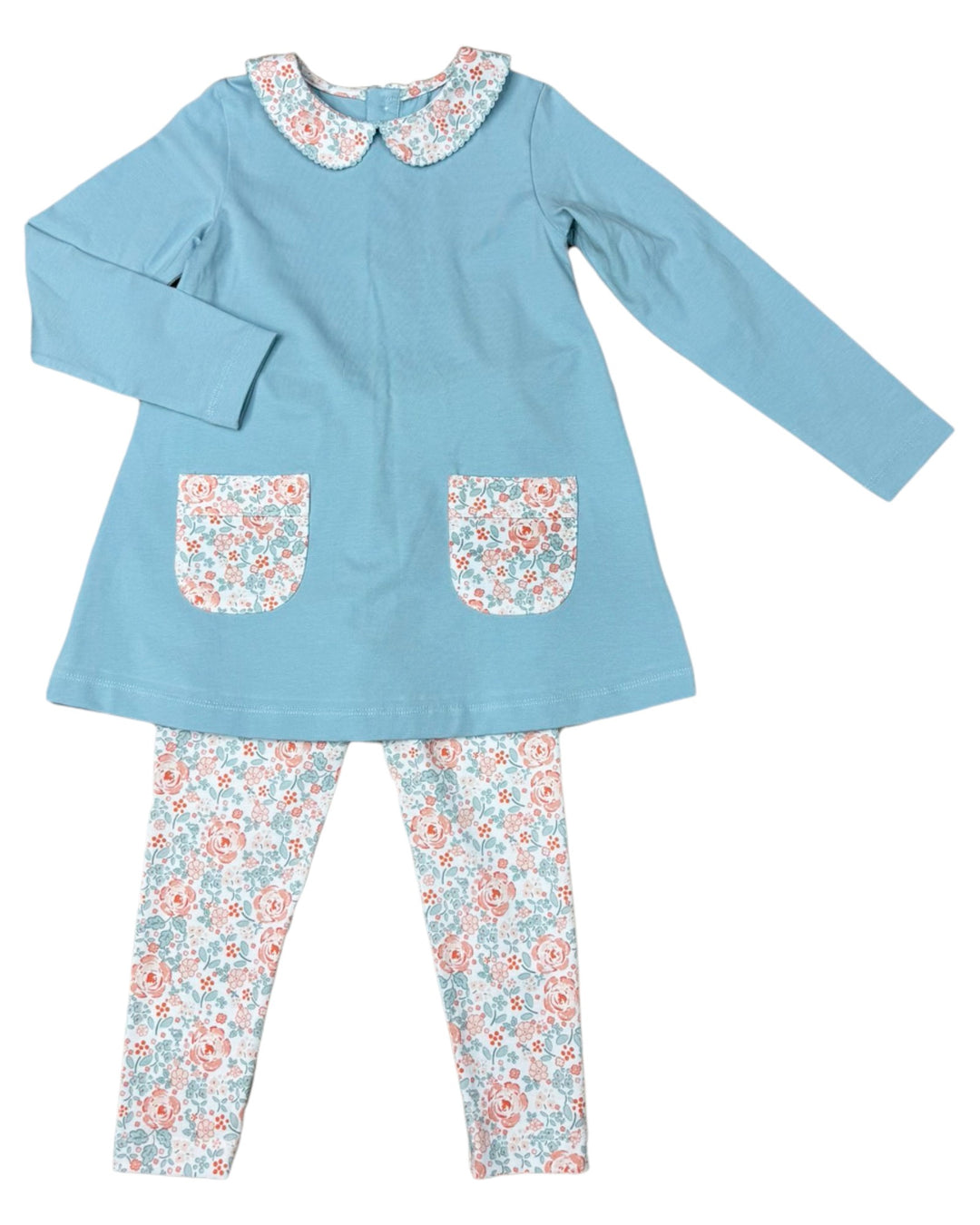 Children's outfit with blue top and floral leggings on a white background