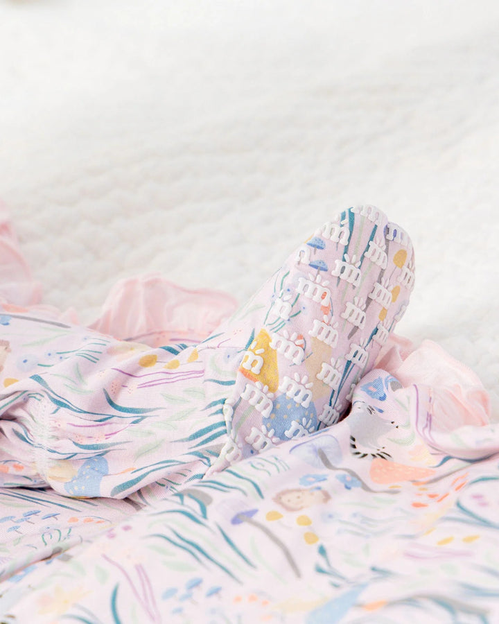 Colorful children's socks with cartoon designs on a white background