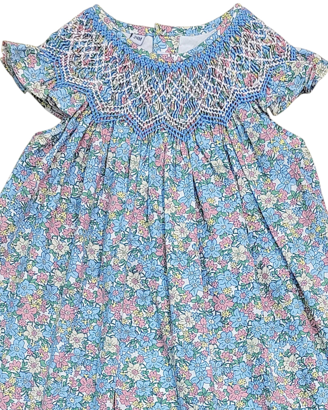 Floral dress with smocked neckline on a white background, that store