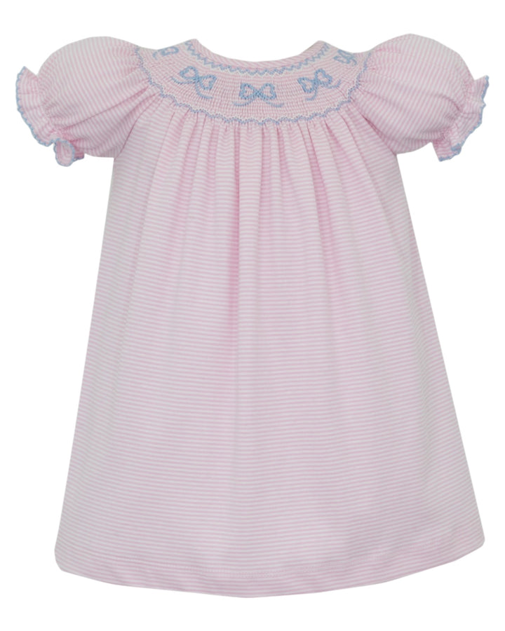 A pink and white striped baby smocked dress with short ruffled sleeves and blue bow embroidery around the neckline, shown against a plain white background, that store