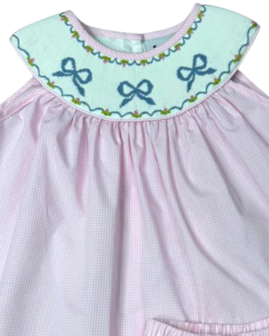 Pink dress with a light blue collar featuring embroidered bows on a white background