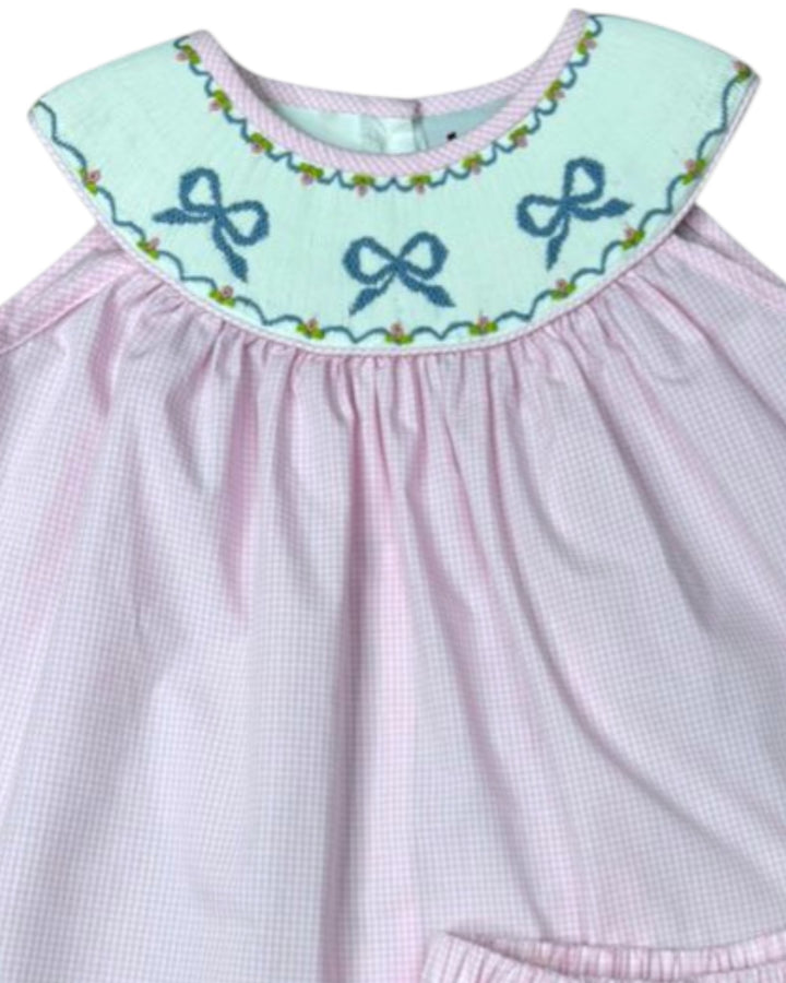 Pink dress with a light blue collar featuring embroidered bows on a white background