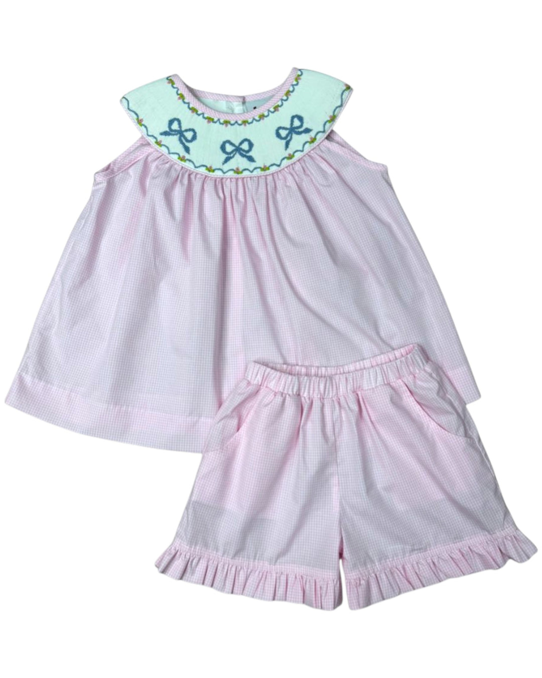 Pink dress and shorts set with decorative collar on a white background