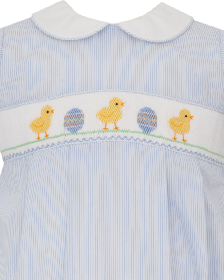 Light blue baby romper with smocked chicks and eggs on a white background