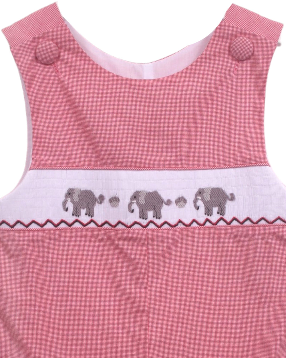 Close-up of a pink sleeveless garment, likely a baby romper or dress, featuring a white smocked band with embroidered gray elephants and paw prints, that store