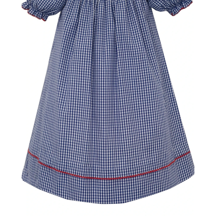 That Store blue gingham smocked bishop dress with red trim detail on the hem and puff sleeves