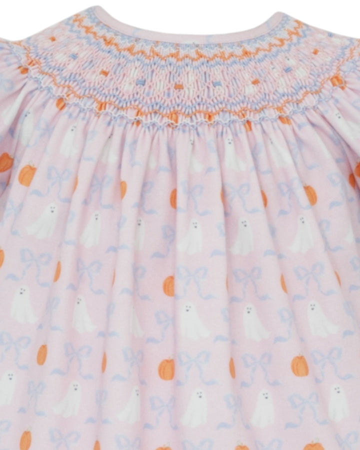 Close-up of a baby dress with smocked neckline and floral pattern
