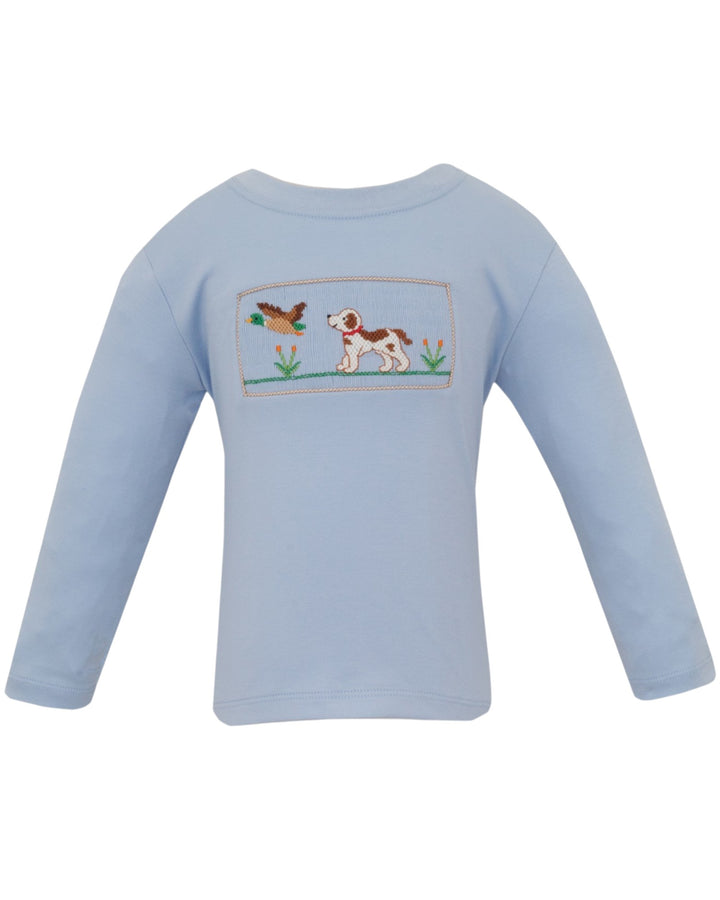 A light blue long-sleeve baby t-shirt with a rectangular embroidered patch on the chest depicting a hunting dog and a duck, that store