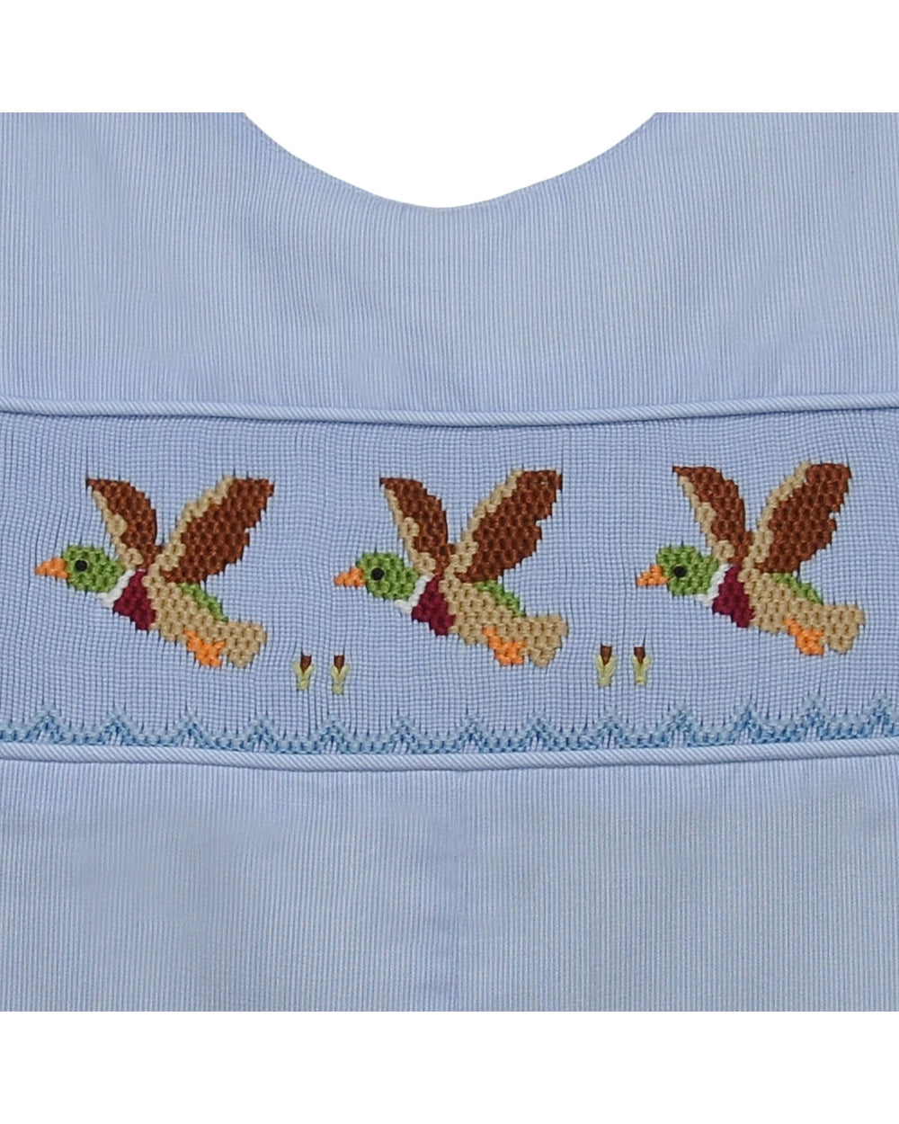 Light blue fabric with embroidered birds and flowers on a white background