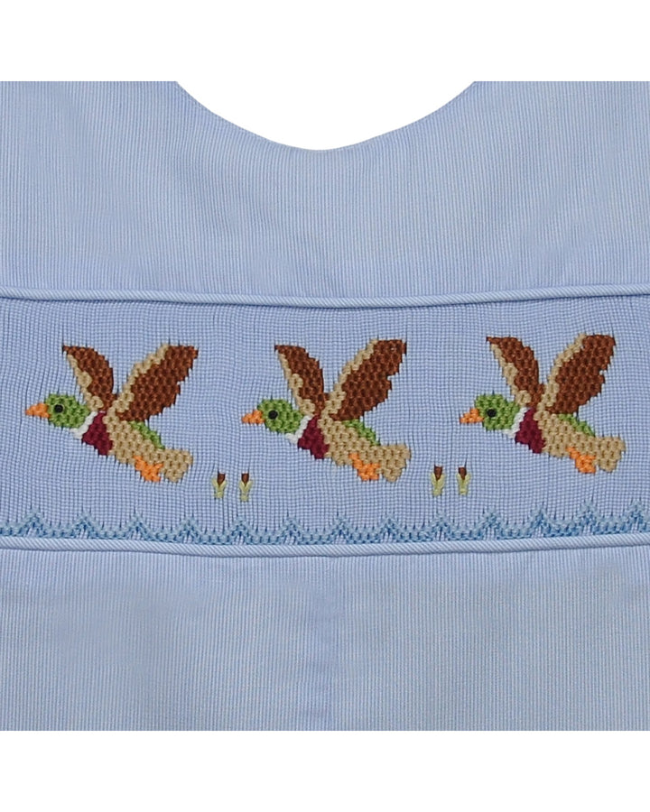 Light blue fabric with embroidered birds and flowers on a white background
