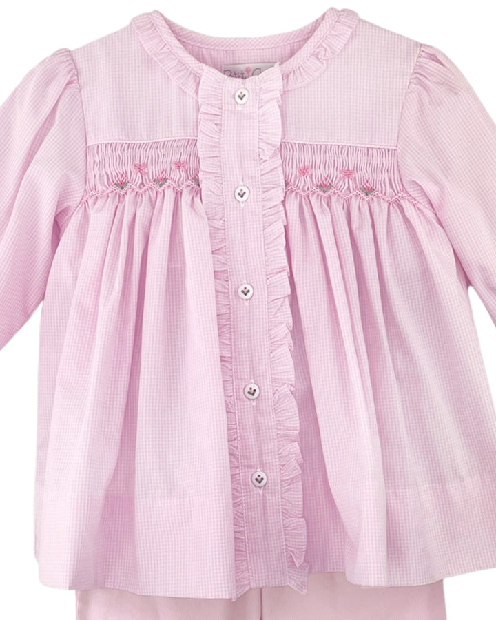 Pink checkered blouse with smocked details on a white background