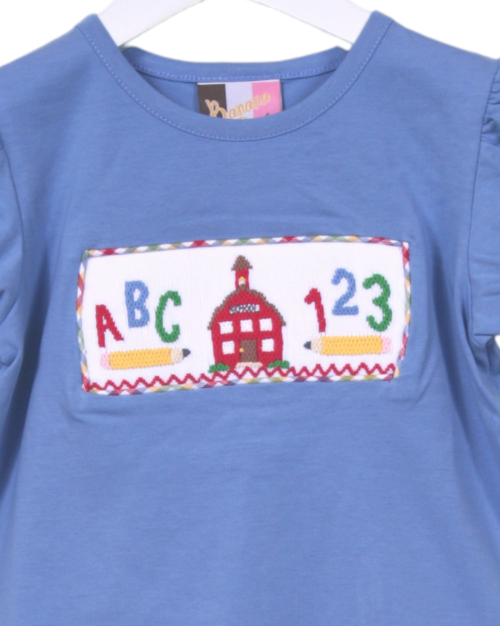 Blue shirt with colorful educational design on a hanger