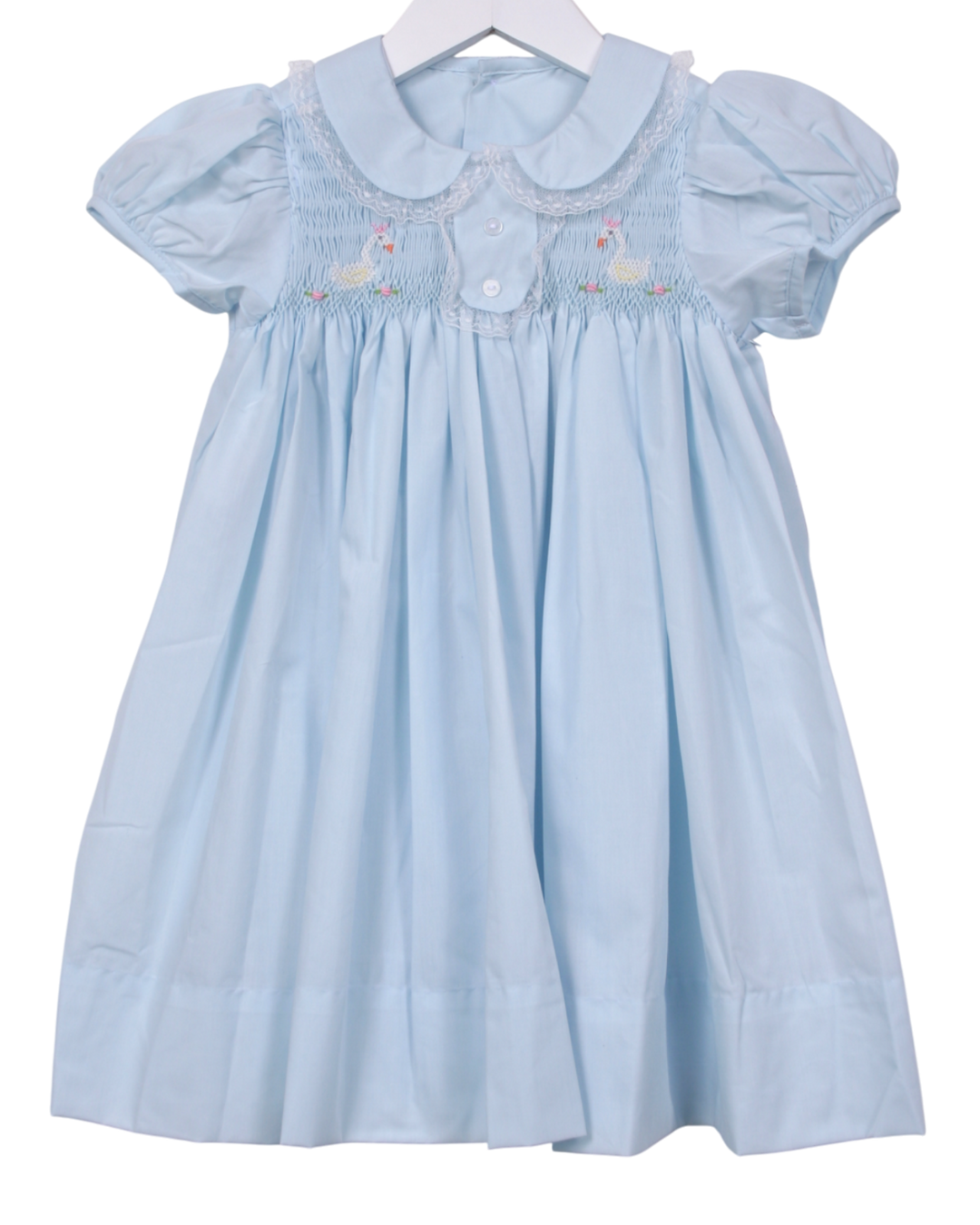 Light blue dress with smocked details on a white background