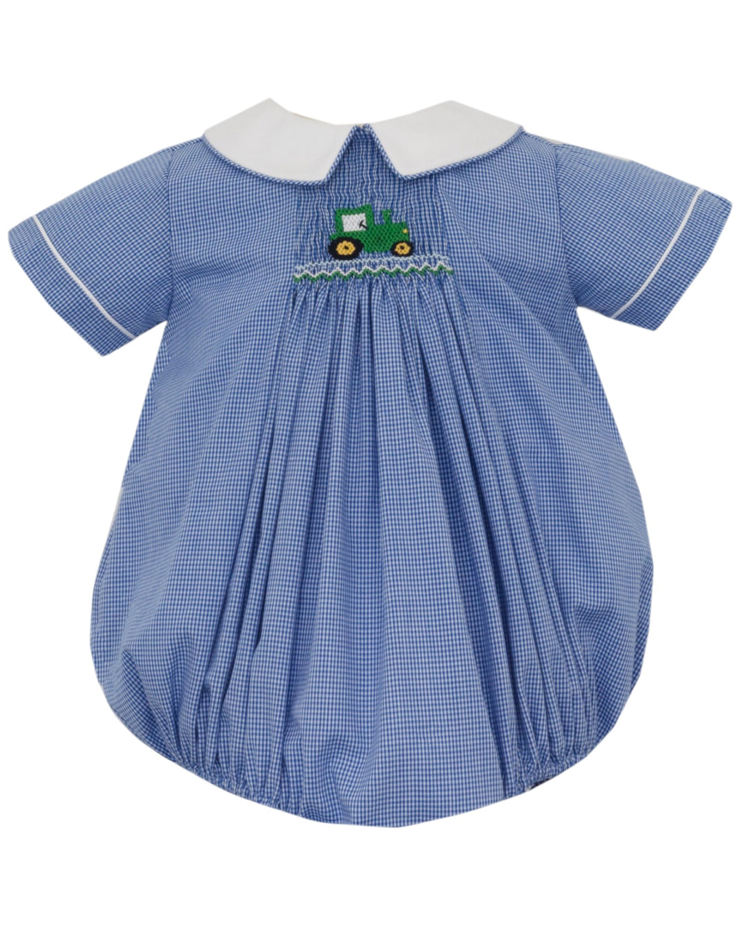 A baby short-sleeve dress in a blue and white gingham pattern, featuring a white Peter Pan collar, white piping, and a smocked chest detail with a green tractor motif, that store