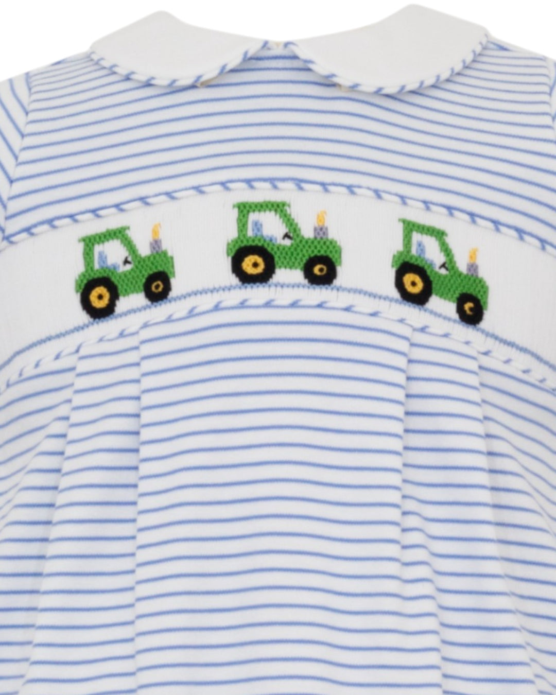 Striped shirt with smocked green tractor pattern on a white background