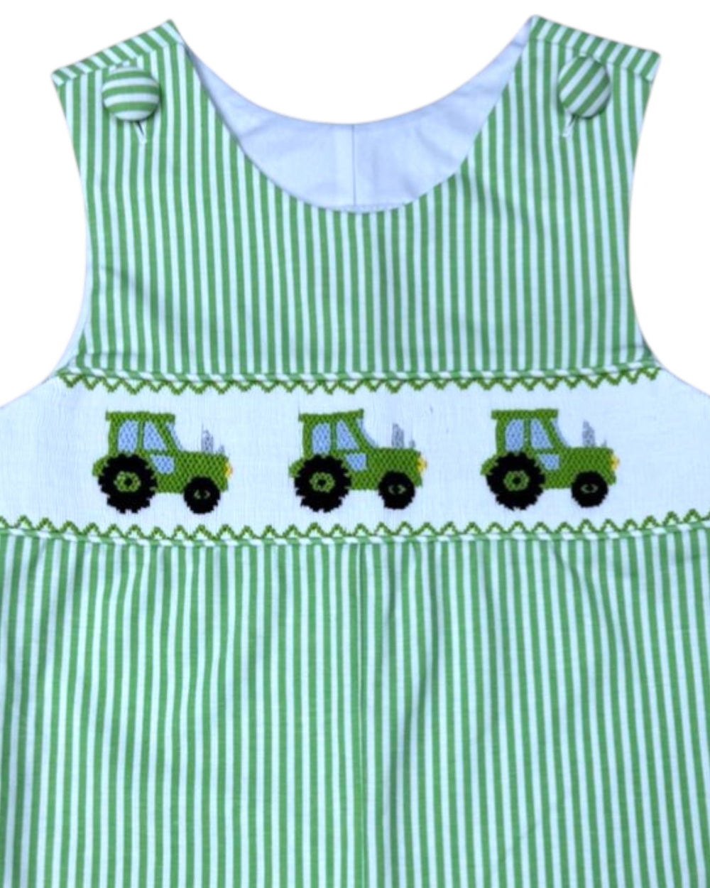 Green and white striped dress with embroidered tractors on a white background