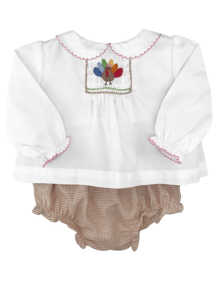 White blouse with embroidered turkey design and brown checkered bloomers on a white background