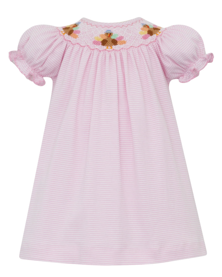 Pink striped dress with floral smocking on a white background