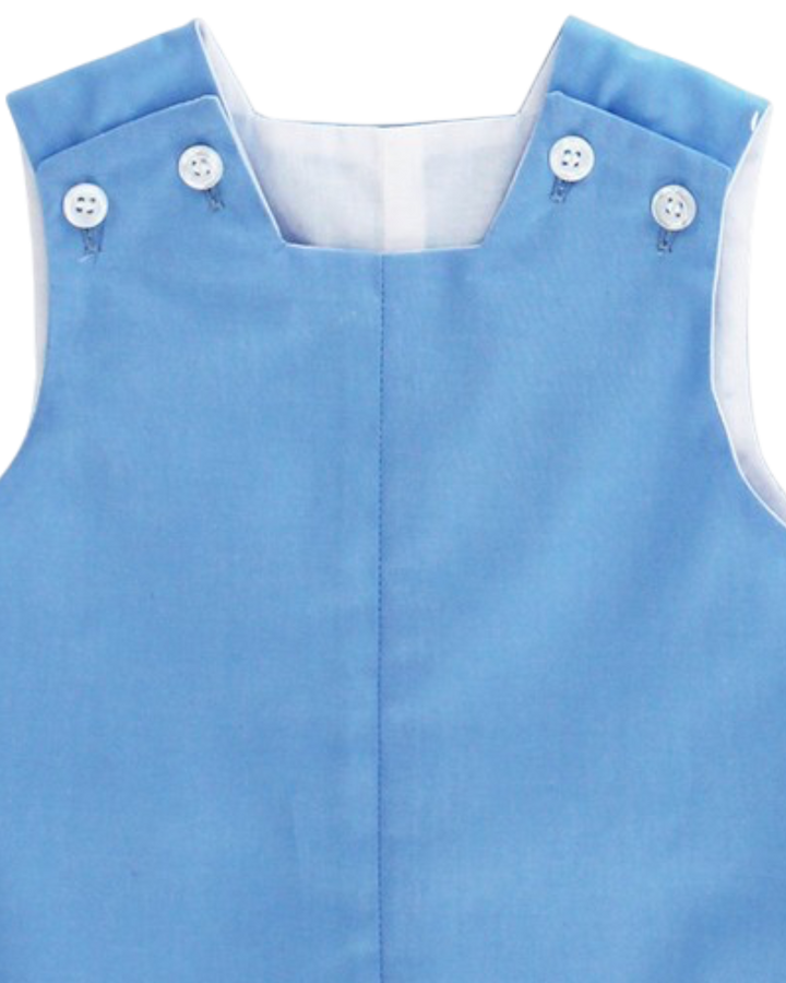 Blue dress with white buttons on a white background