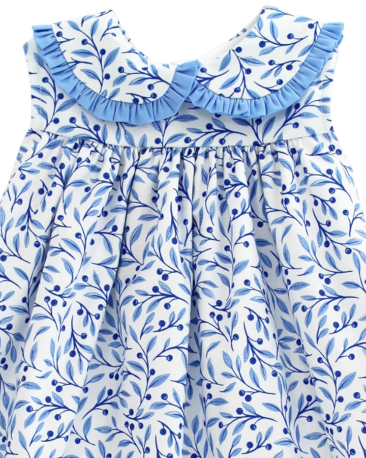 Blue and white floral dress with ruffled neckline on a white background