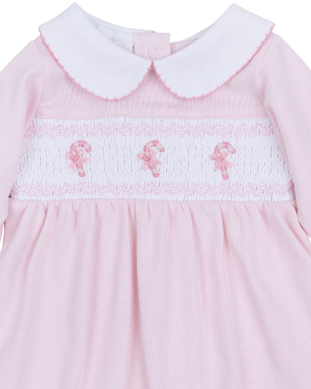 Pink dress with white collar and embroidered details on a white background