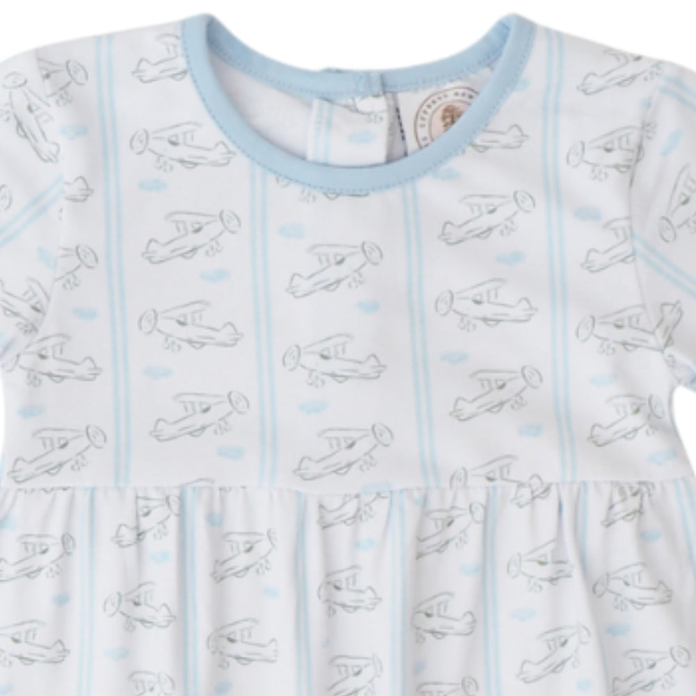 A close-up of a baby dress featuring a white base with light blue vertical stripes, a light blue crew neck, and an allover print of simple black line drawings of vintage airplanes, that store