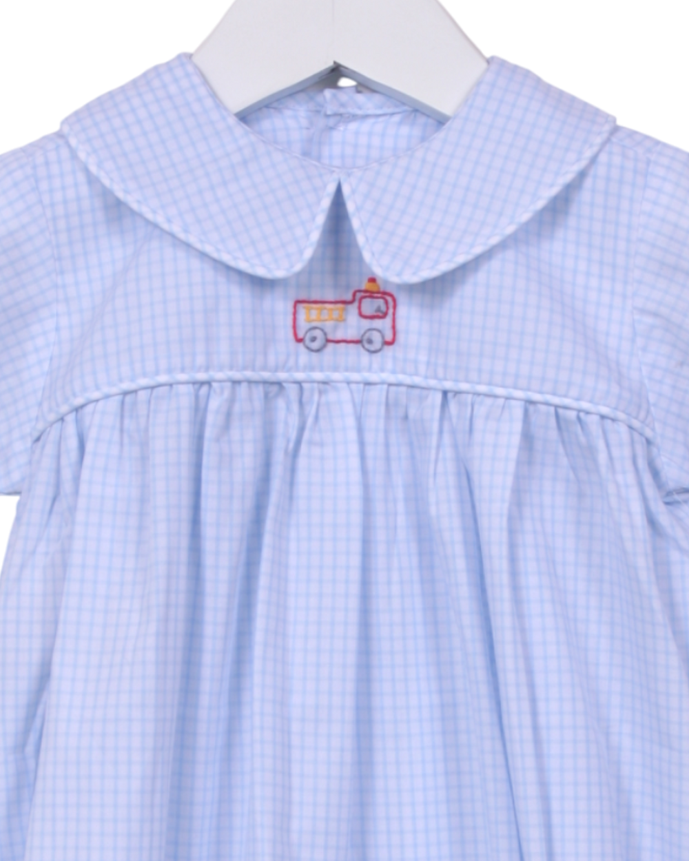 Blue embroidered bubble  with a red and white fire truck design on a hanger