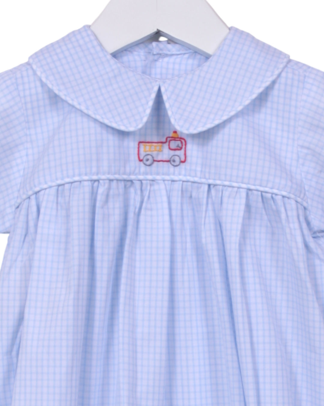 Blue embroidered bubble  with a red and white fire truck design on a hanger