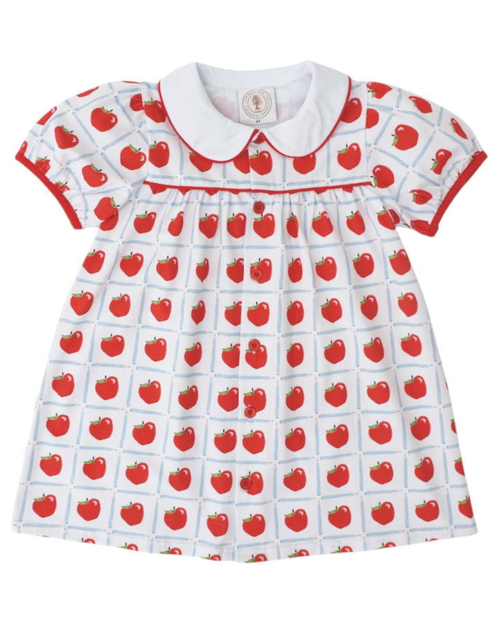 Children's dress with red apple pattern on a white background