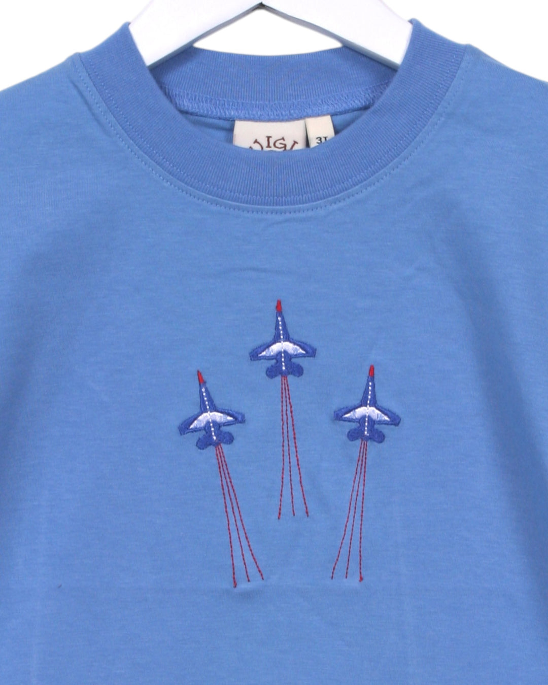 Blue sweatshirt with embroidered airplane designs on a white background