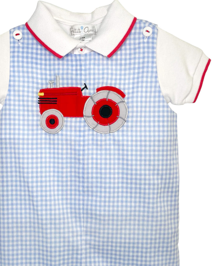 Children's outfit with red tractor design on blue checkered background
