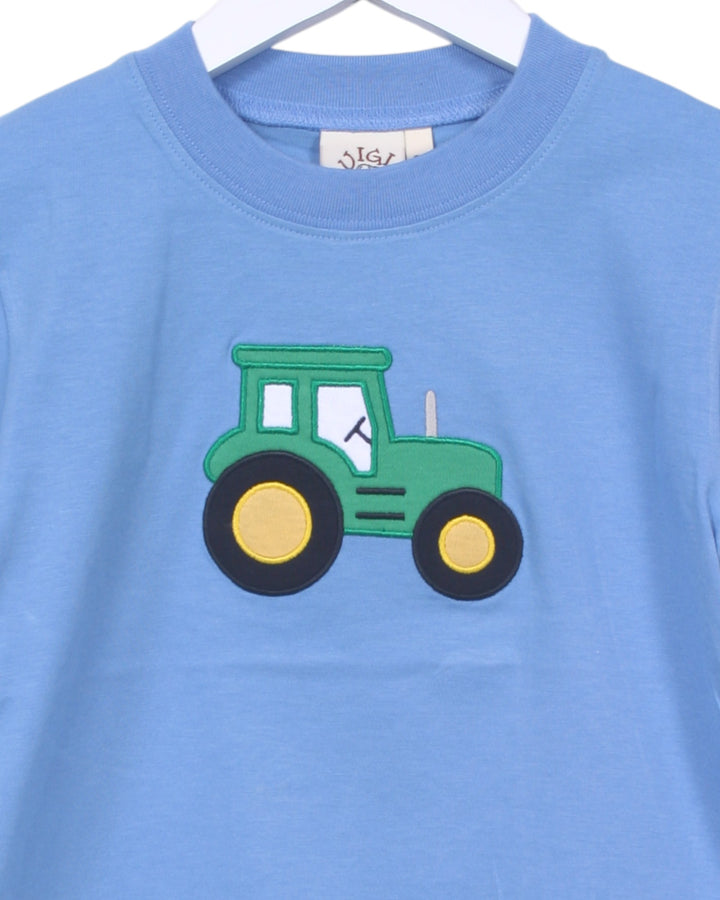 Blue t-shirt with a green tractor design on a white background