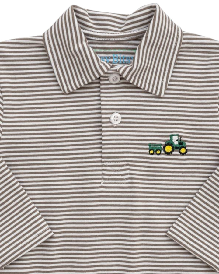 Striped polo shirt with a tractor emblem on a white background