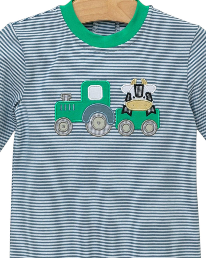Children's t-shirt with a green tractor and cow design on a striped background