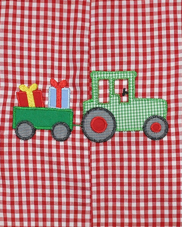 Green tractor with red on a red and white checkered fabric