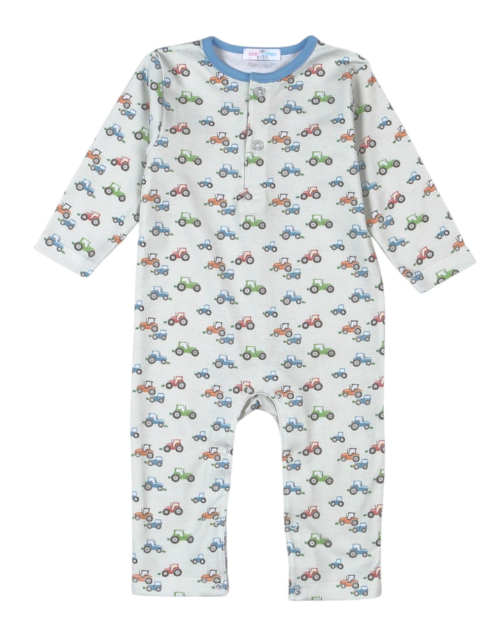 A baby long-sleeve romper in off-white with an all-over tractor print in green, blue, and orange, featuring a light blue collar and a three-button henley neckline, that store