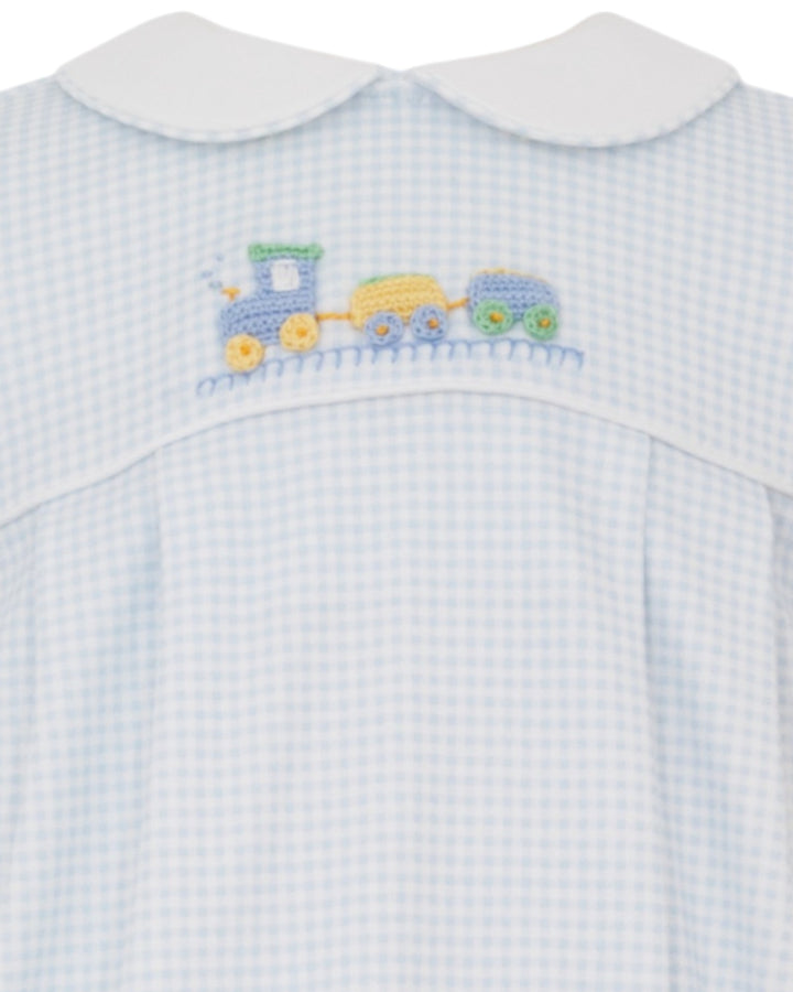 Baby outfit with blue checkered pattern and embroidered train design on a white background
