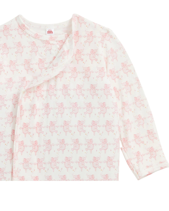 A long-sleeve baby wrap top in white with a repeating light pink teddy bear pattern, shown on a plain white background, that store
