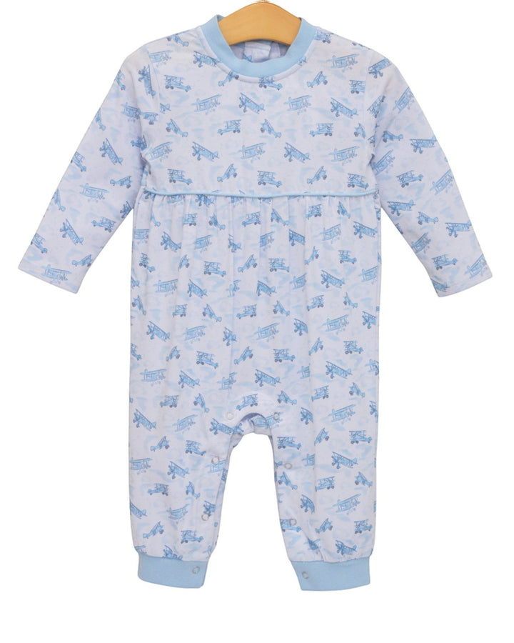 A baby long-sleeve footless one-piece jumpsuit in white with a light blue repeating airplane pattern, featuring light blue ribbed collar, cuffs, and hem, hanging on a wooden hanger against a white background, that store